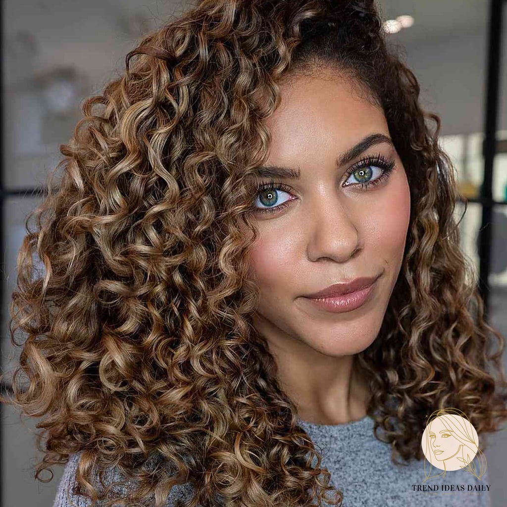 25 Cute Hairstyles For Medium Hair Curly Perfect for Your Next Salon Appointment 13 Blonde Curls with a Deep Side Part