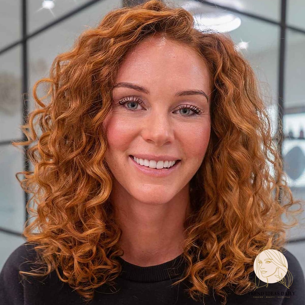 25 Cute Hairstyles For Medium Hair Curly Perfect for Your Next Salon Appointment 14 Copper Curls with a Side Part