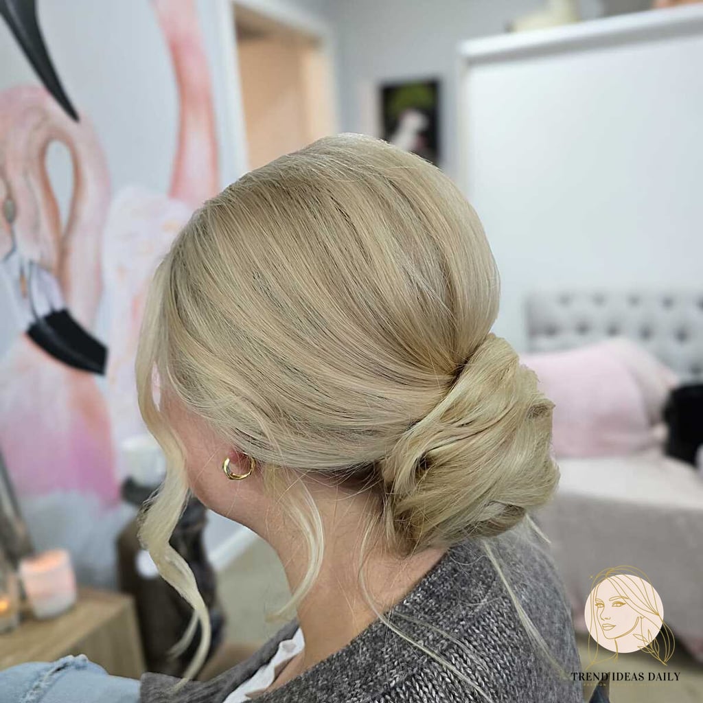 9 Bun Hairstyles Short Hair We're Obsessed With Right Now 5 Loose Gathered Bun with Tendril on Creamy Blonde Hair
