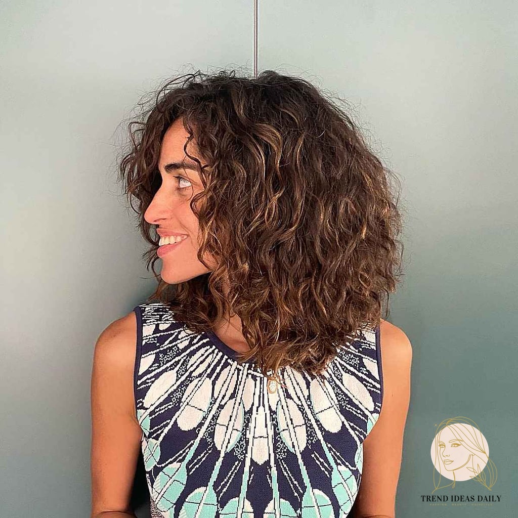 25 Cute Hairstyles For Medium Hair Curly Perfect for Your Next Salon Appointment 18 Natural Layered Curly Cut