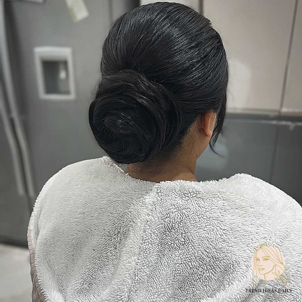 9 Bun Hairstyles Short Hair We're Obsessed With Right Now 9 Smooth Rolled Chignon on Jet Black Hair